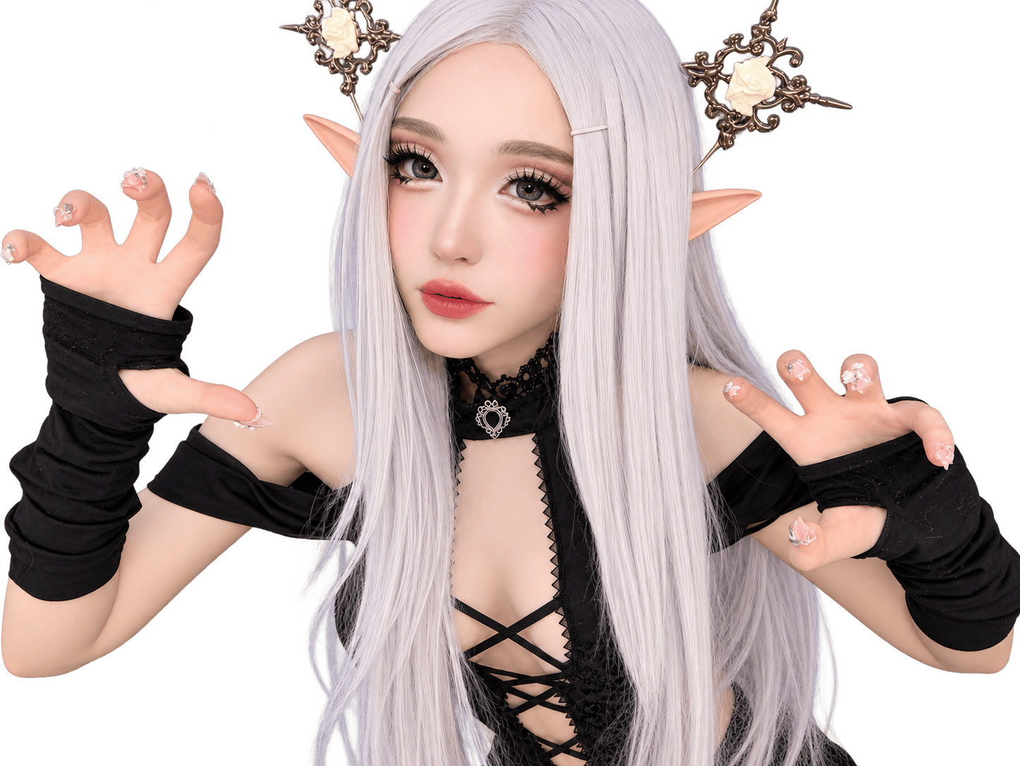A silver-haired elf cosplayer wearing a black gothic lace outfit, pointed ears, an ornate rose headpiece, and black arm warmers, posing with both hands raised.